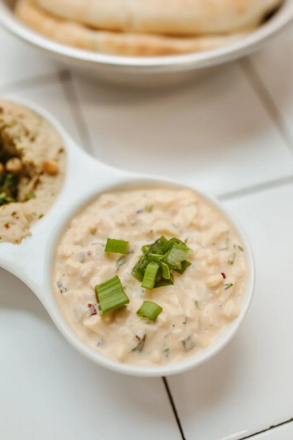 Creamy crab dip topped with green onions