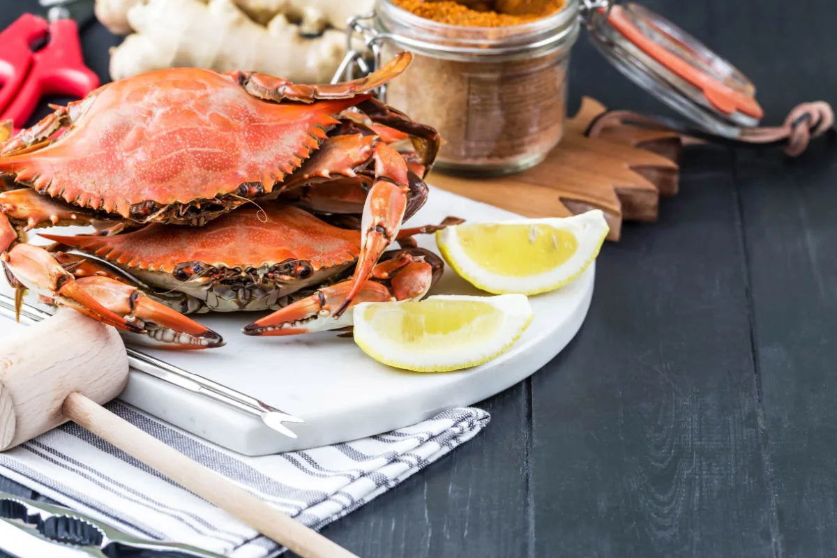 Friends sharing a Maryland crab feast at a paper-covered table