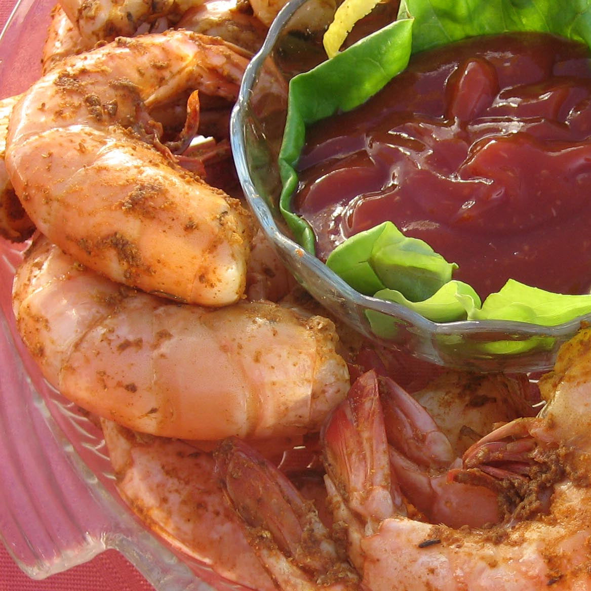 Steamed and seasoned jumbo Gulf shrimp with cocktail sauce, close-up
