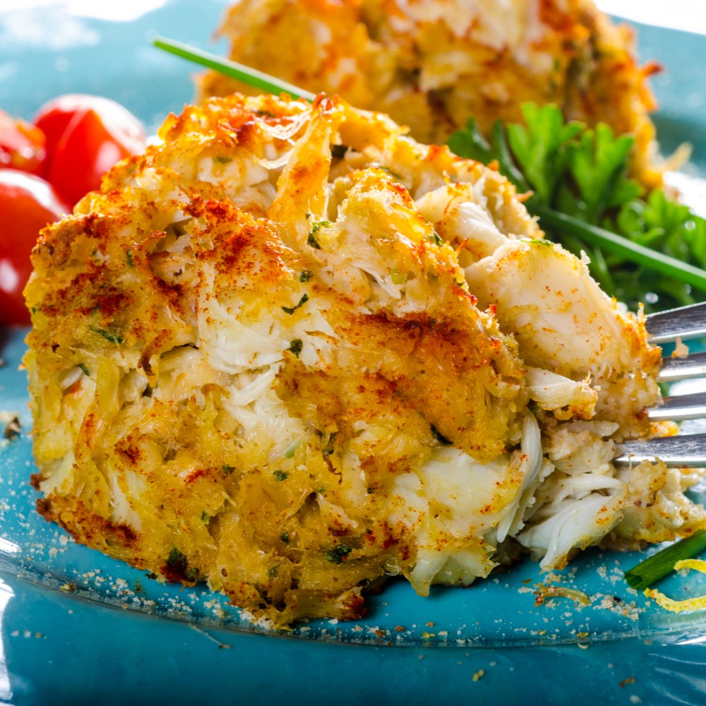 Jumbo lump crab cake, broiled golden and plated with a fork