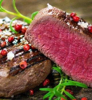 Grilled beef tenderloin halved to reveal a pink center