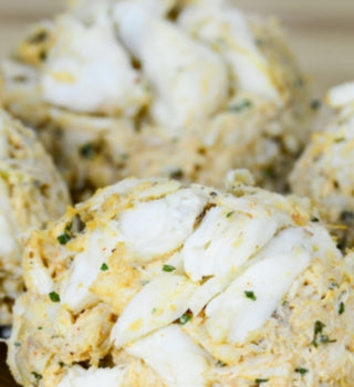 Jumbo lump crab cake flecked with parsley, close-up