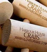 Wooden crab mallets engraved with Harbour House Crabs, close-up