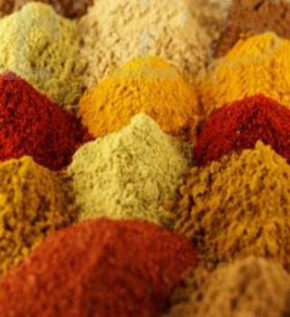 Mounds of red, orange and yellow ground spices for crab seasoning